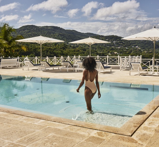 a woman in a swimsuit standing in a pool