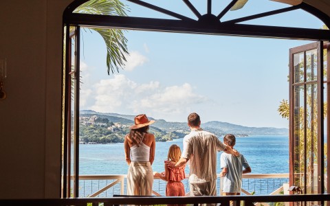 a group of people looking out a window at a body of water
