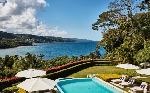a pool with a body of water in the background