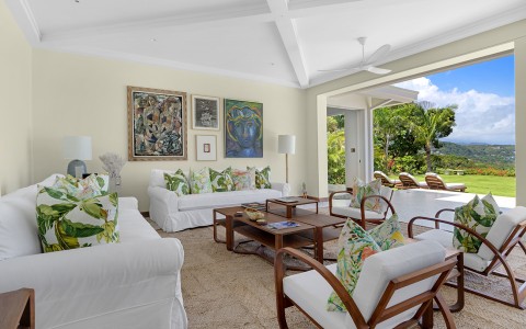 a living room with white couches and a coffee table