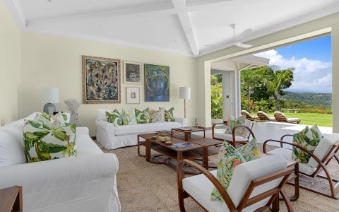 a living room with white couches and a coffee table