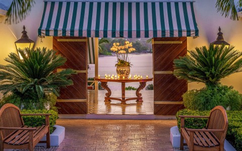 a table with candles on it and a green and white striped awning