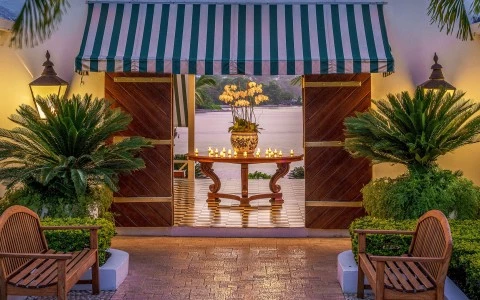 a table with candles on it and a green and white striped awning