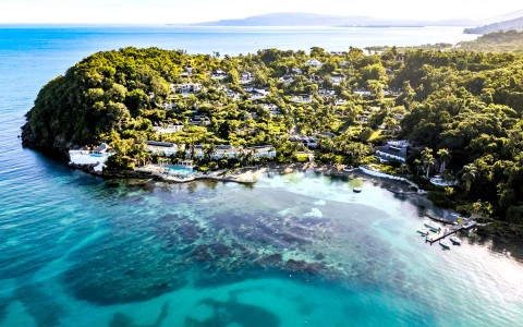 a body of water with houses and trees