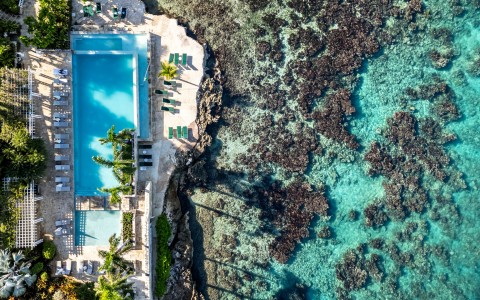 a pool next to a rocky beach