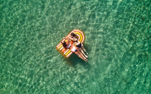 a group of women floating on an inflatable raft in the water