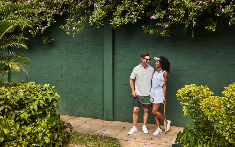 a man and woman holding tennis rackets