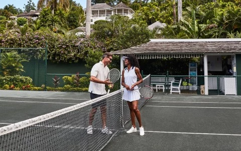 a man and woman standing on a tennis court