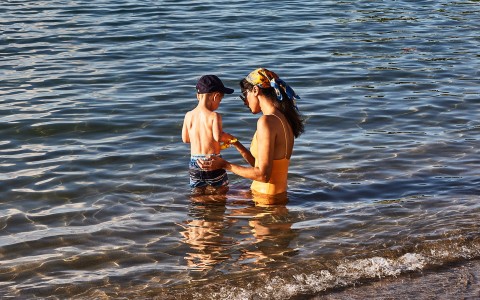 a woman and child in water
