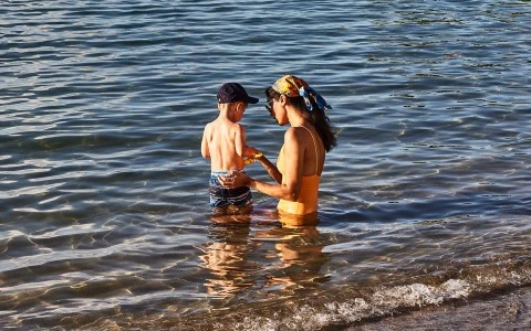 a woman and child in water