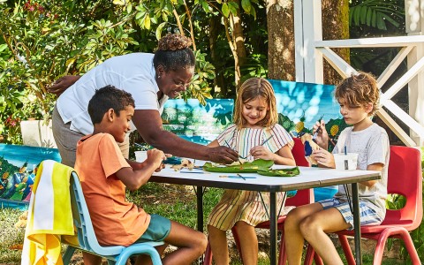 a group of kids sitting at a table