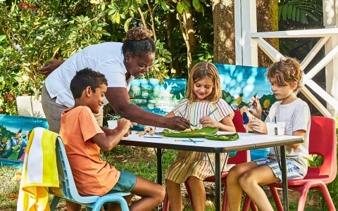 a group of kids sitting at a table