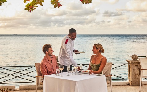 a man serving food to a group of people