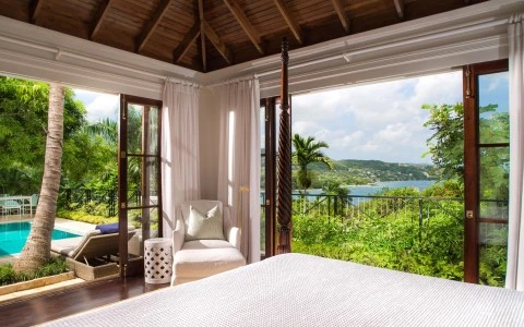a room with a bed and a view of the ocean