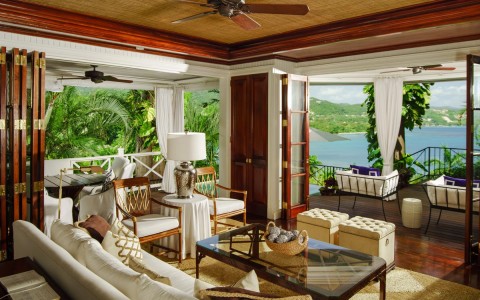 a living room with a view of the ocean