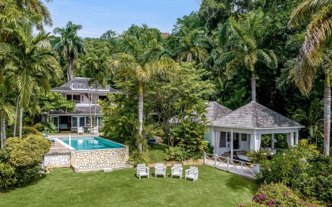 a pool in a yard with trees around it