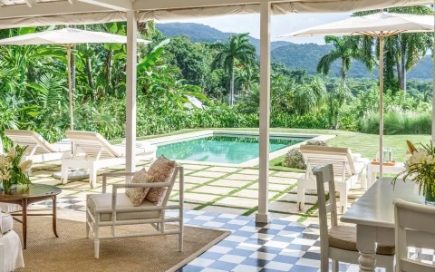 a pool with chairs and chairs in front of a pool