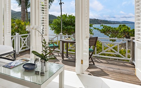a room with a view of the ocean and a table
