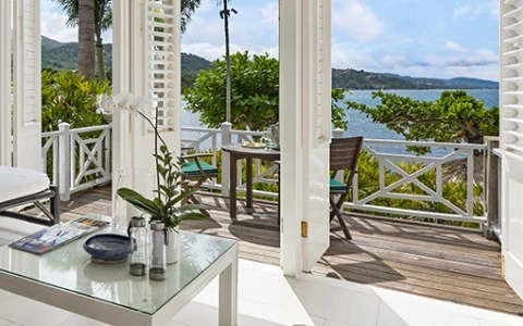 a room with a view of the ocean and a table