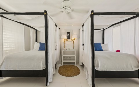 a room with four beds and a table