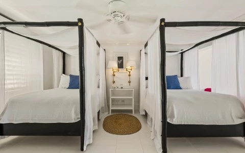 a room with four beds and a table