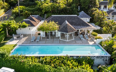 a swimming pool with a house and trees