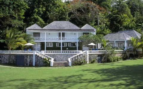 a house with a stone wall and a stone wall