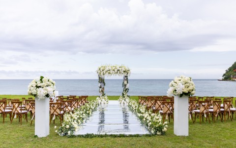 a wedding ceremony set up with chairs and a mirror