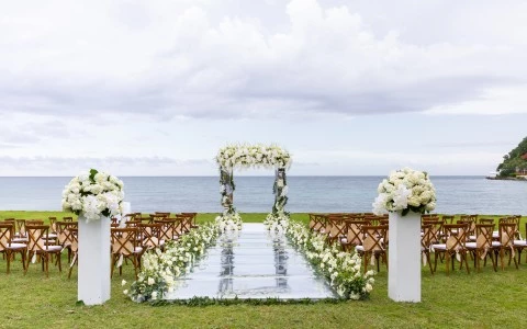 a wedding ceremony set up with chairs and a mirror