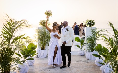 a man and woman walking down a dock