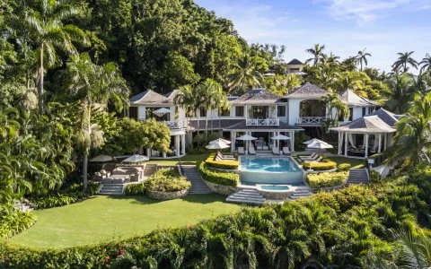 a large house with a pool and trees