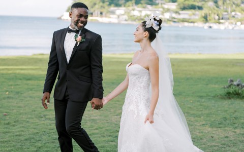 a man and woman in a wedding dress holding hands
