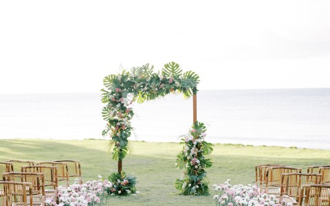 a wedding ceremony with chairs and flowers