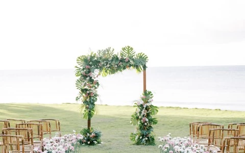 a wedding ceremony with chairs and flowers
