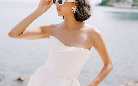 a woman in a white dress and sunglasses