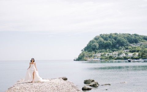 a woman in a white dress on a beach