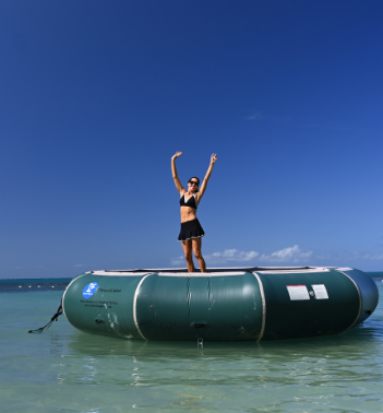 a woman standing on a raft in the water