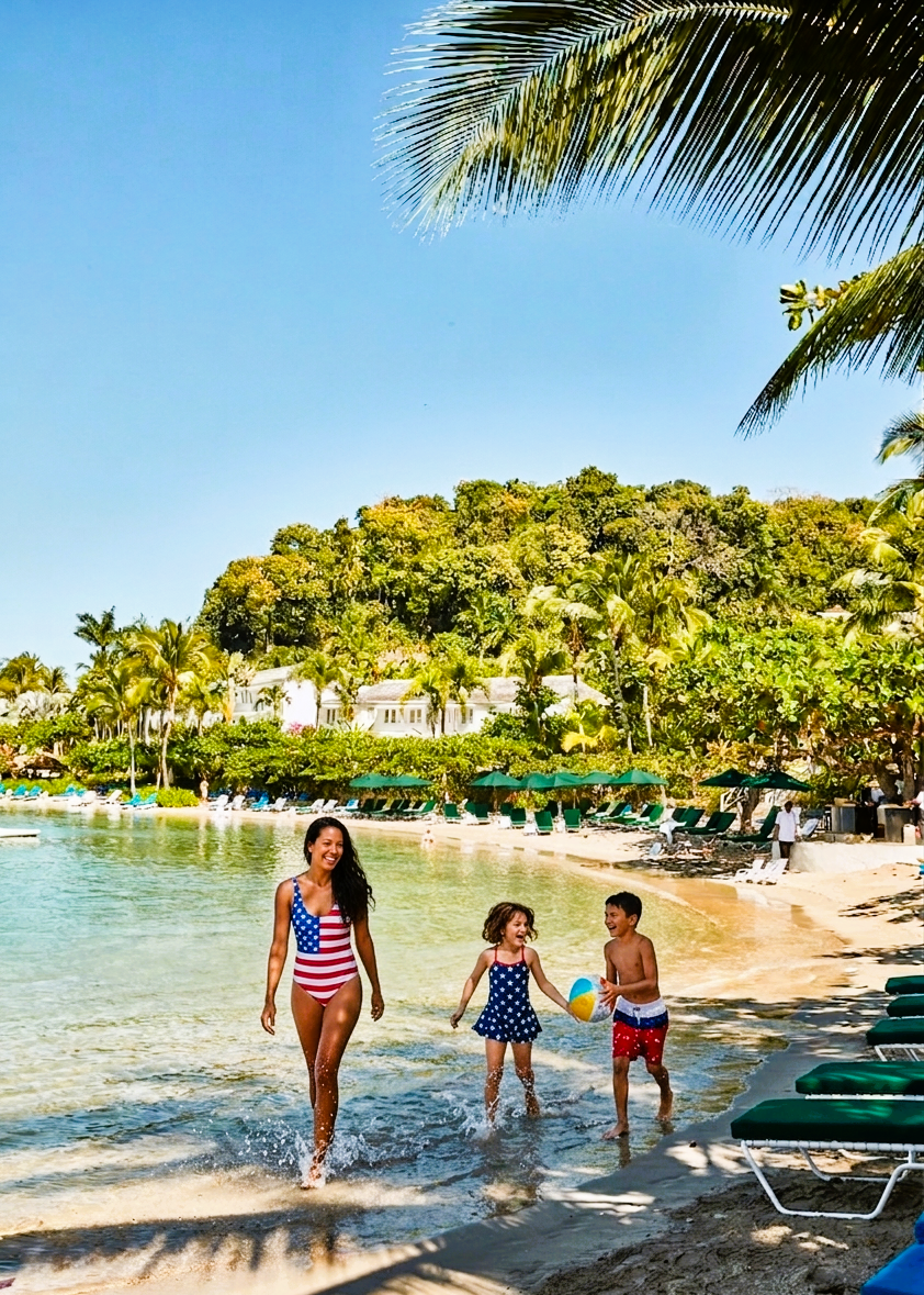 a woman and kids on a beach