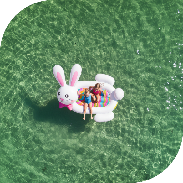 two girls on an inflatable raft in the water