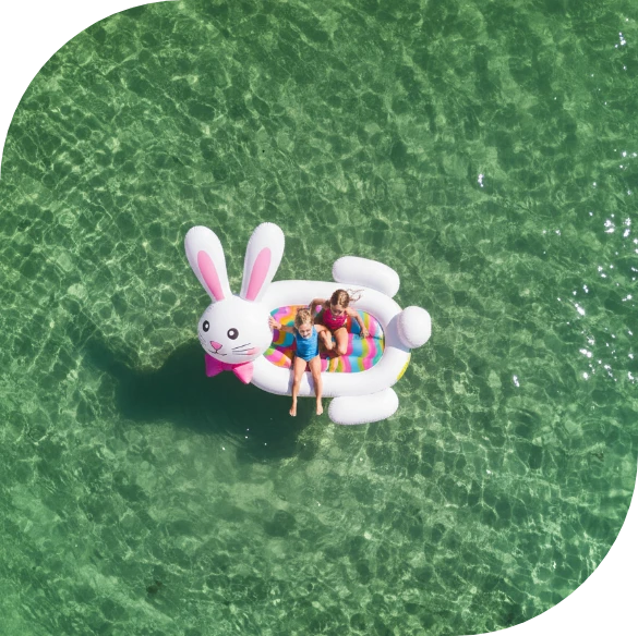 two girls on an inflatable raft in the water