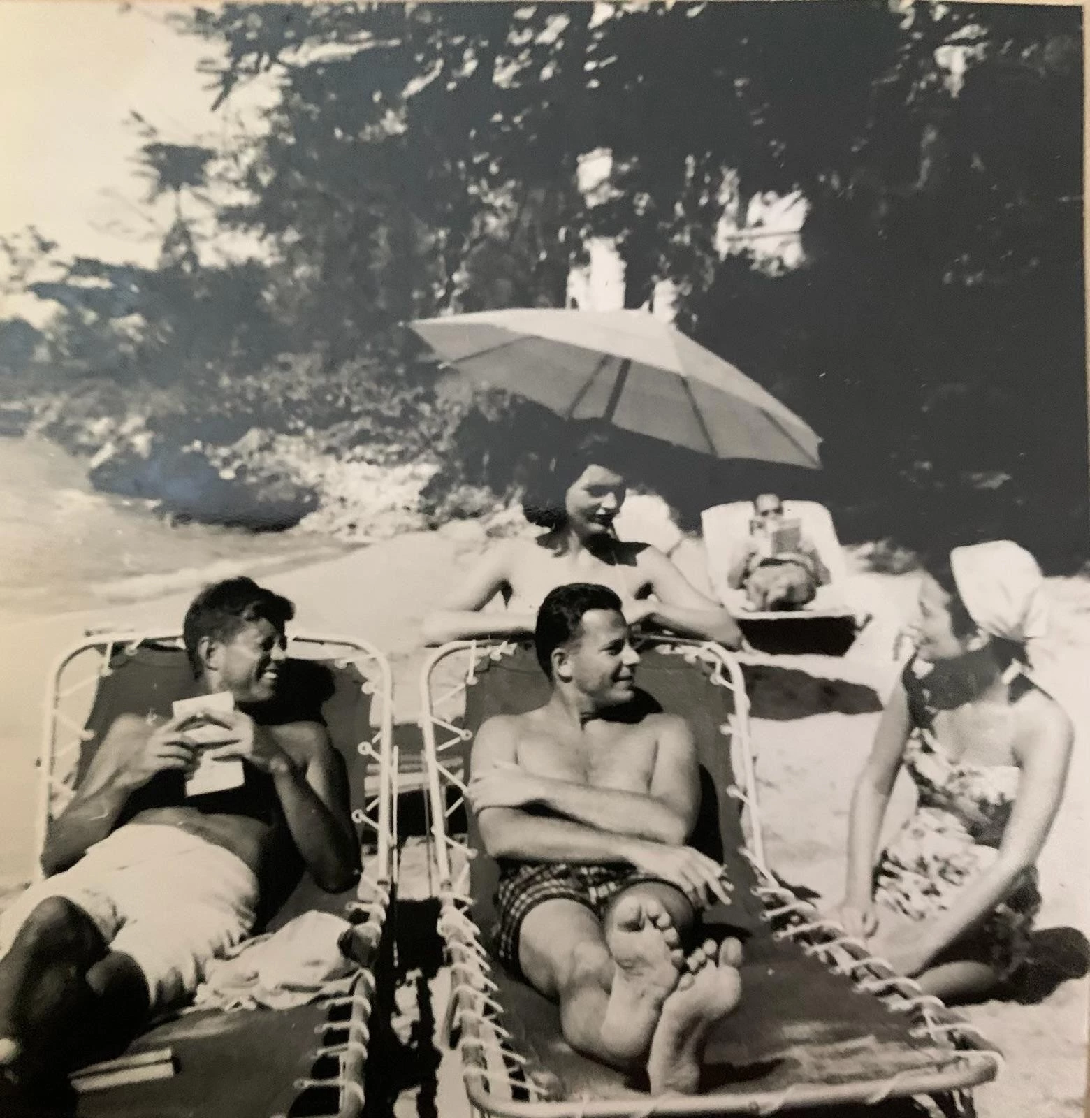 a group of people sitting on chairs on a beach
