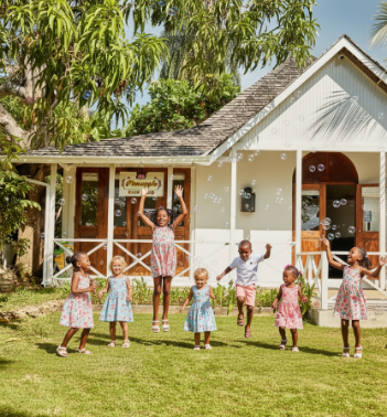 a group of children playing outside of a house