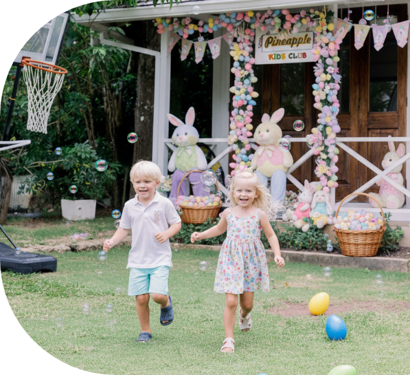 a boy and girl running in front of a building with easter eggs and baskets