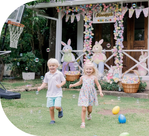 a boy and girl running in front of a building with easter eggs and baskets