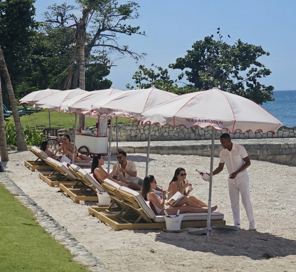 a group of people sitting in lounge chairs under umbrellas on a beach