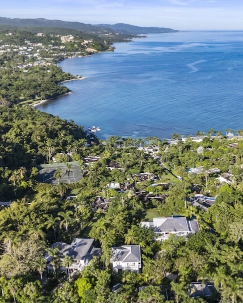a body of water with houses and trees