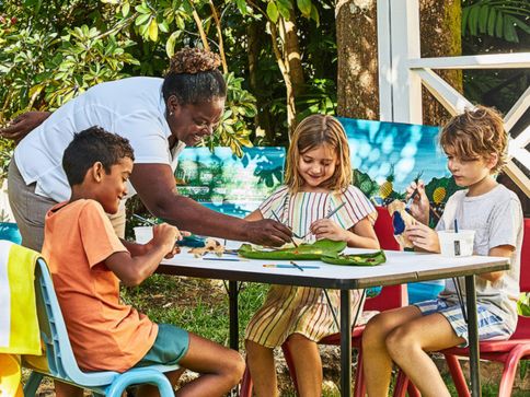 a group of kids sitting at a table