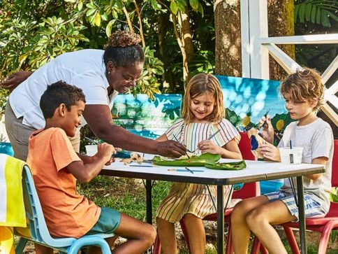 a group of kids sitting at a table