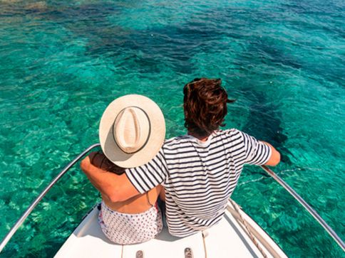 a man and woman sitting on a boat
