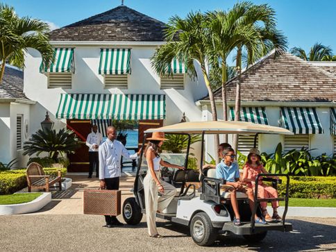 a group of people in a golf cart
